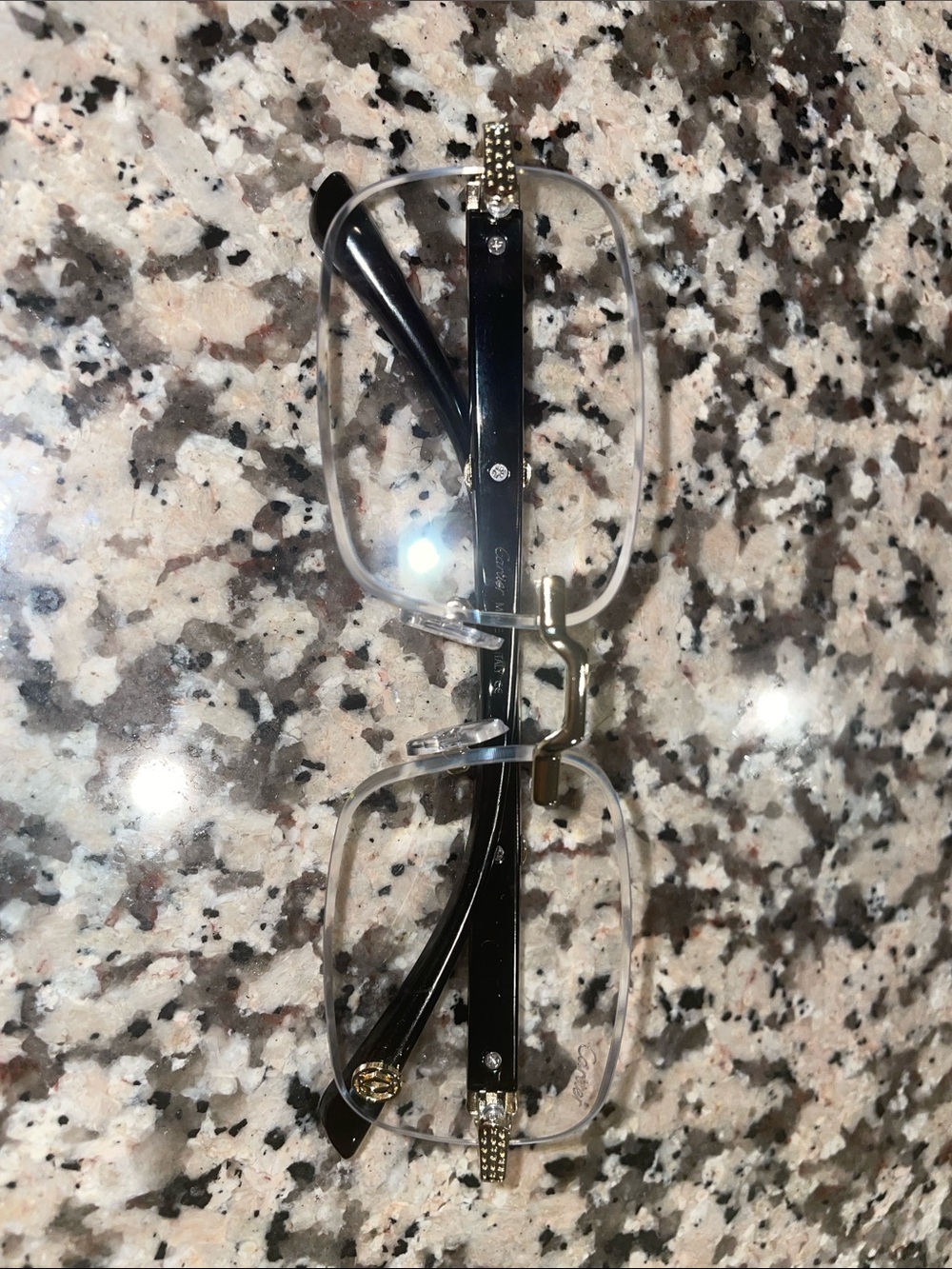 Cartier Rimless Rectangular Glasses with Black Temples and Gold Accents